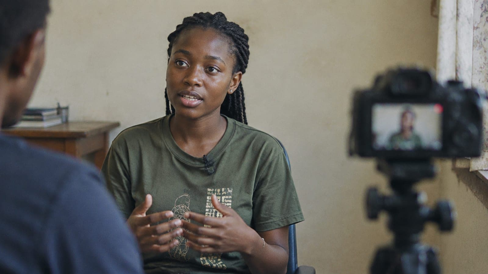 A young woman being interviewed on camera about her work